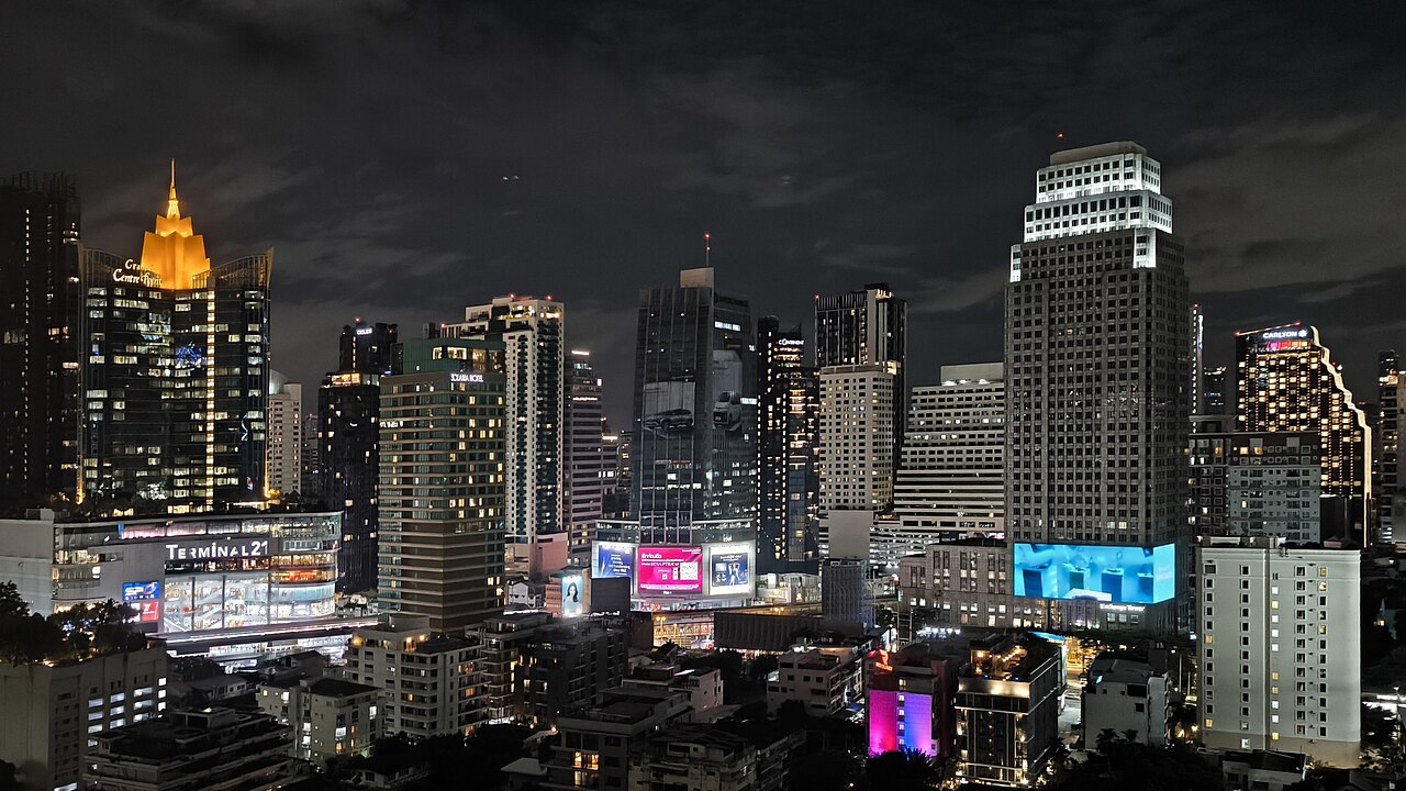 Bangkok towers at night, with a lit golden spire