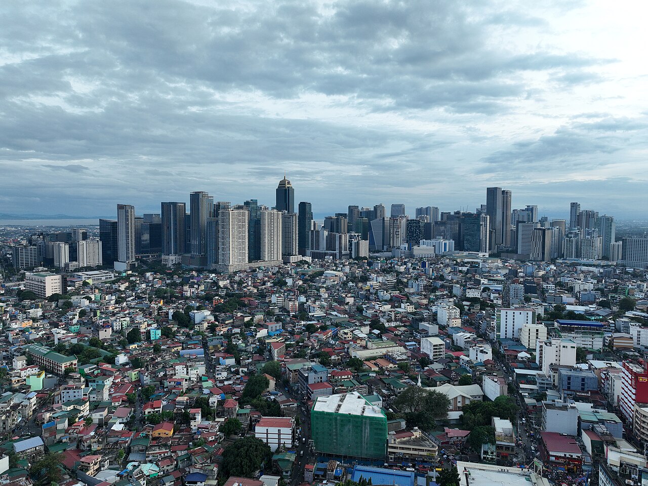 Bonifacio Global City towers rising behind dense low-rise neighbourhoods
