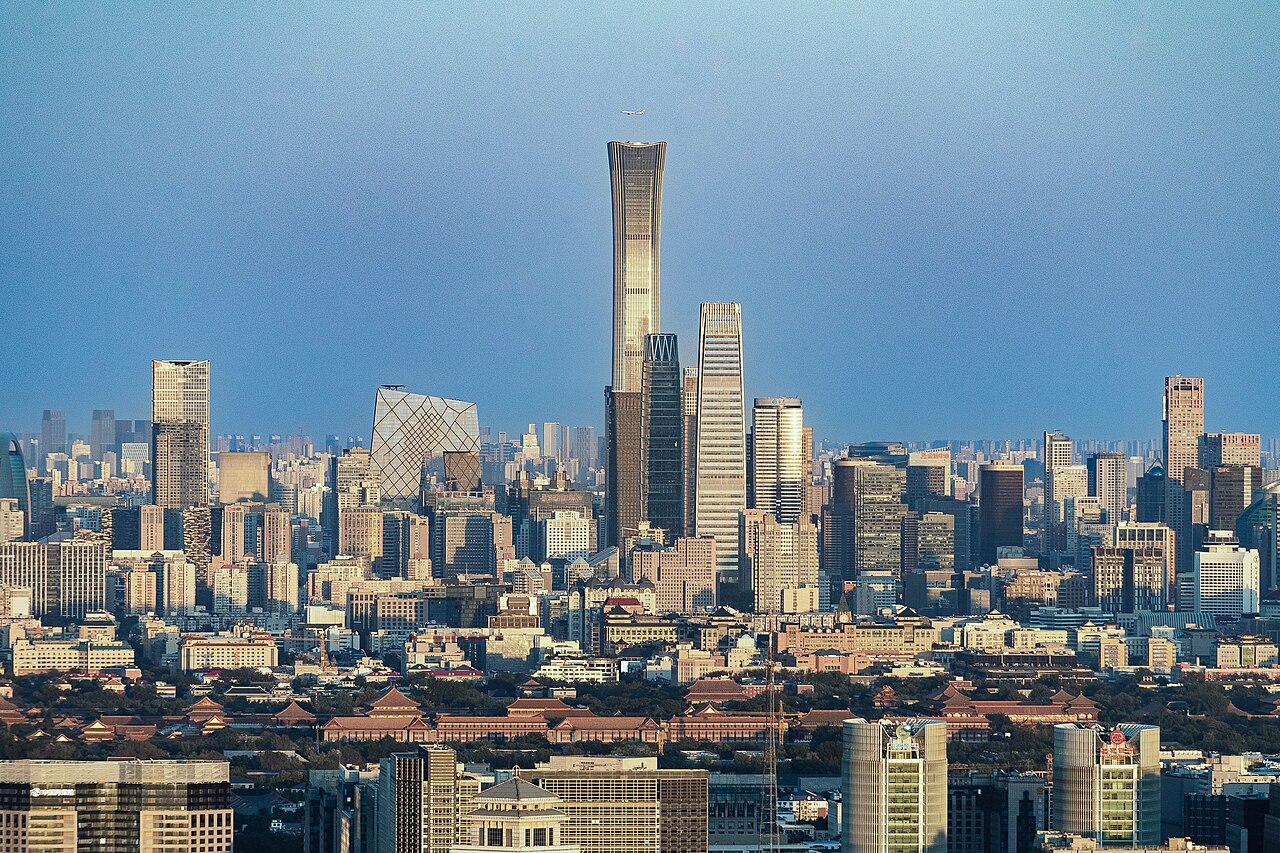 The Beijing central business district skyline, with an aircraft on approach overhead