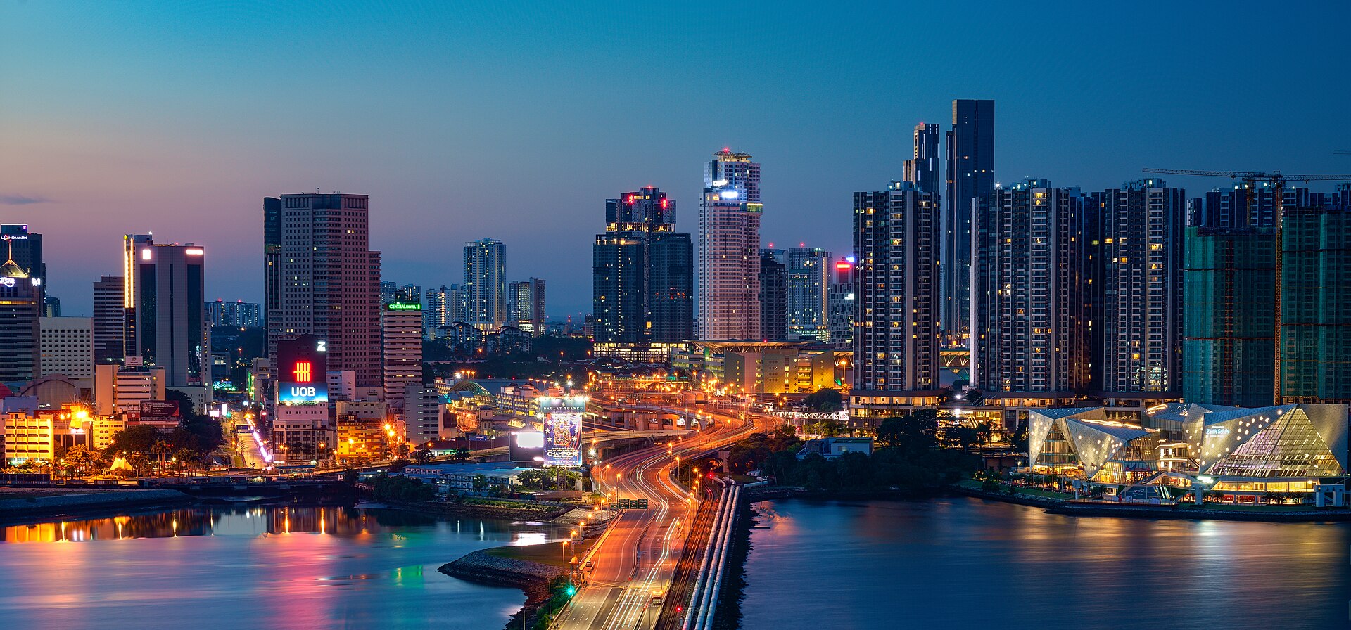 Johor Bahru skyline at dusk, with the causeway approach and the strait in the foreground
