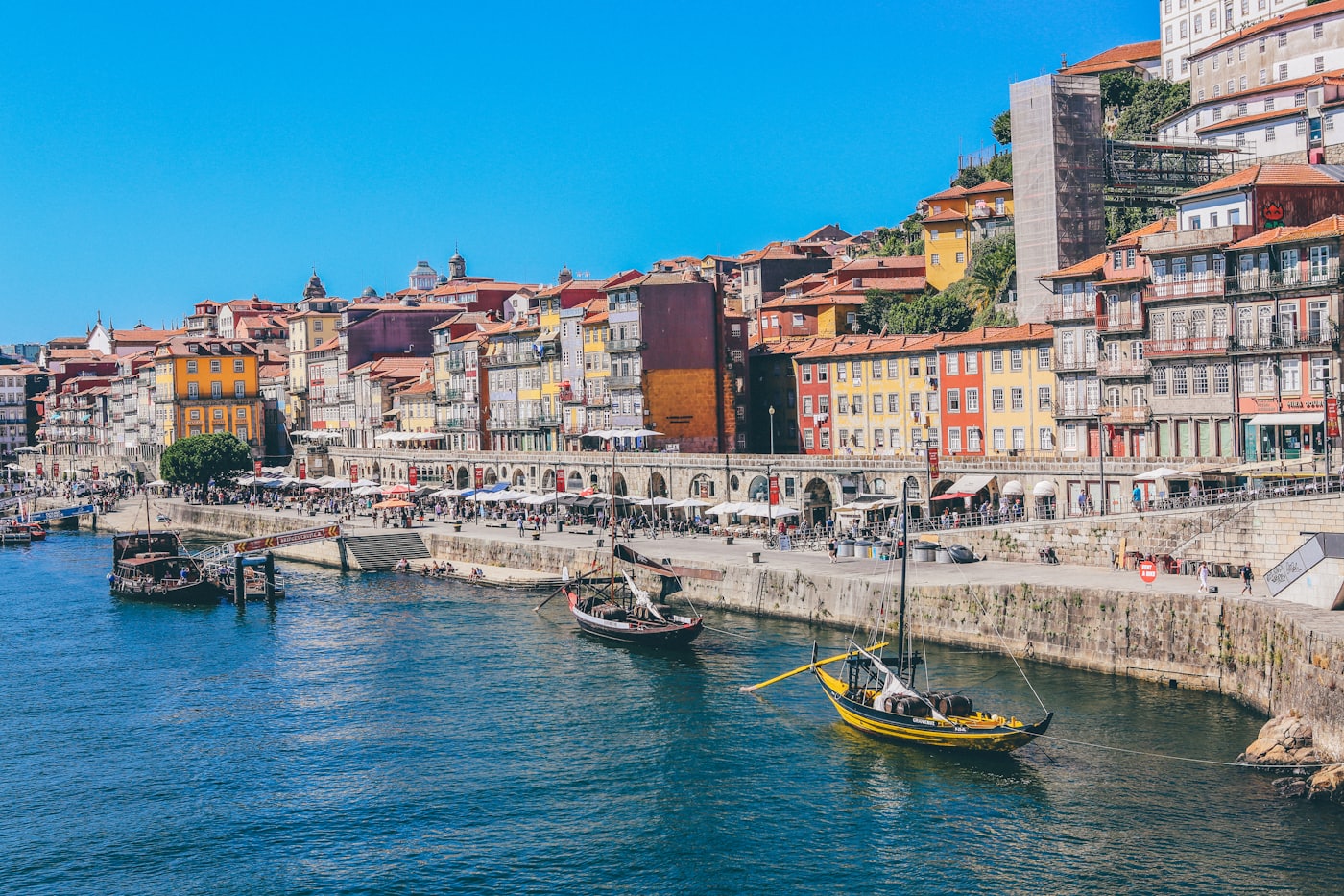 Coastal city of tiled roofs and a stone tower by the water