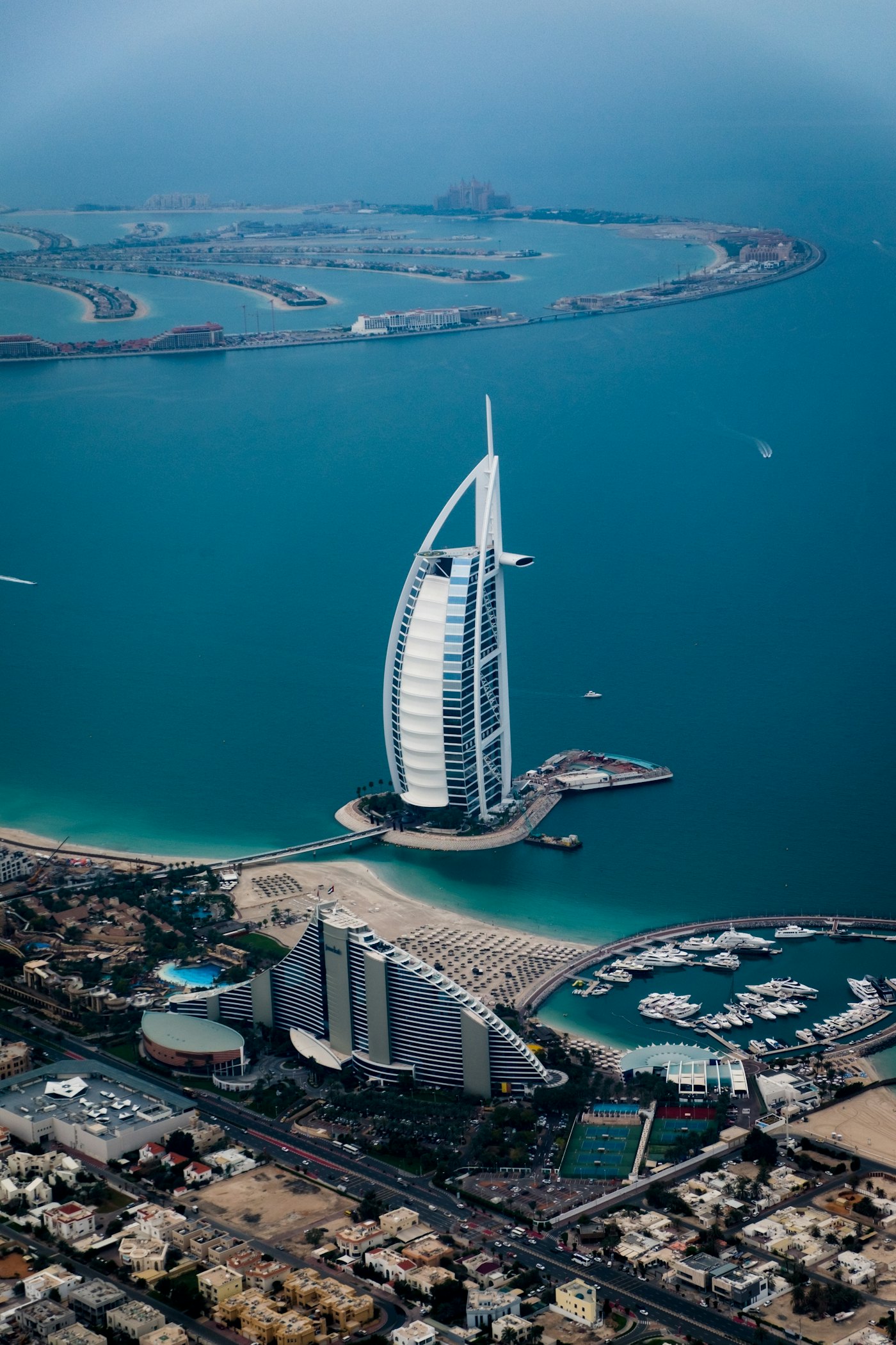 Dubai marina towers reflected in still water at dusk